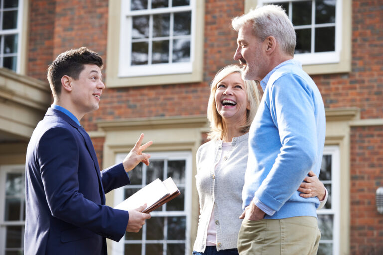 A man and woman consult with a real estate agent.