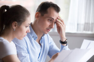 A man and woman reviewing documents together at a table.